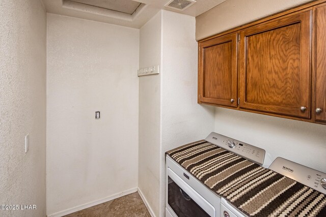 laundry room with cabinets and washer and dryer