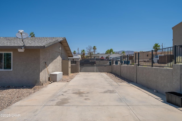 913 Thunderbolt Ave, Lake Havasu City, AZ 86406 - view of patio with a gate, a residential view, and concrete driveway