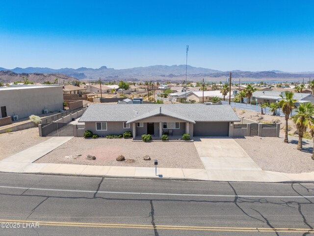 913 Thunderbolt Ave, Lake Havasu City, AZ 86406 - ranch-style house with a mountain view, a garage, concrete driveway, a residential view, and a gate