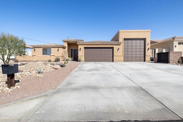 view of front of home featuring fence, an attached garage, stucco siding, concrete driveway, and a tile roof