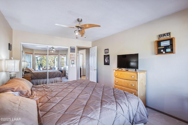 carpeted bedroom with a closet and ceiling fan