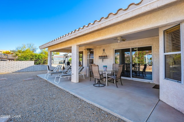 view of patio / terrace featuring ceiling fan, fence, and outdoor dining space
