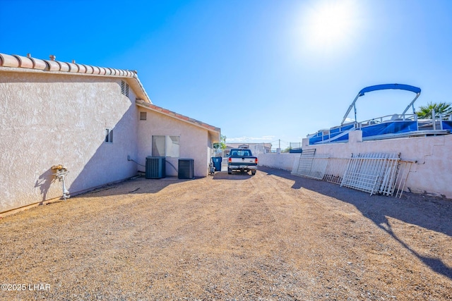 view of yard with fence and cooling unit