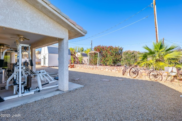 view of yard with ceiling fan