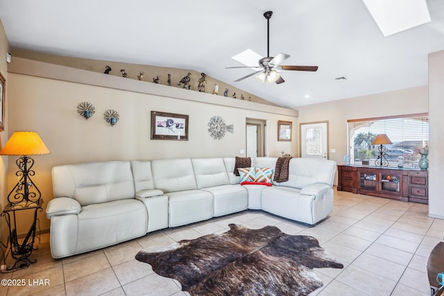 living area with tile patterned flooring, a ceiling fan, visible vents, and lofted ceiling