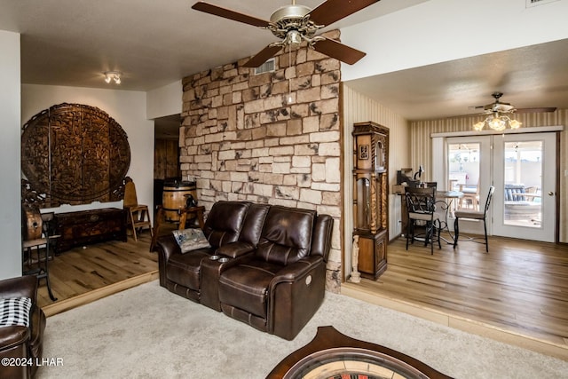 living room featuring ceiling fan and wood-type flooring