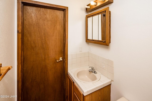 bathroom featuring vanity and decorative backsplash