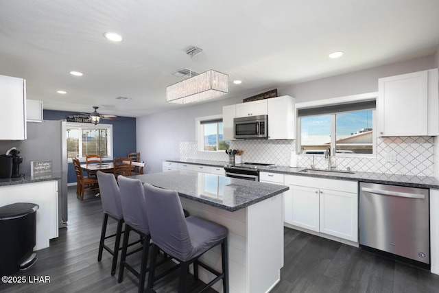 kitchen with white cabinetry, stainless steel appliances, and a sink