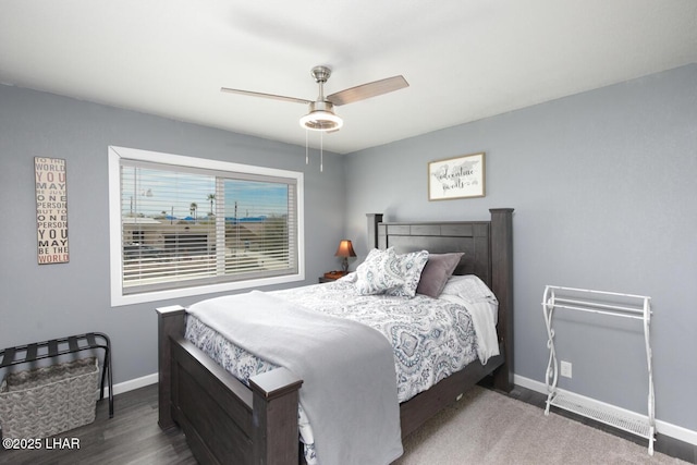 bedroom featuring baseboards, dark wood-type flooring, and a ceiling fan