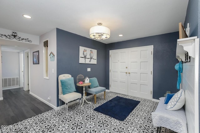 bedroom with baseboards, visible vents, wood finished floors, a closet, and recessed lighting