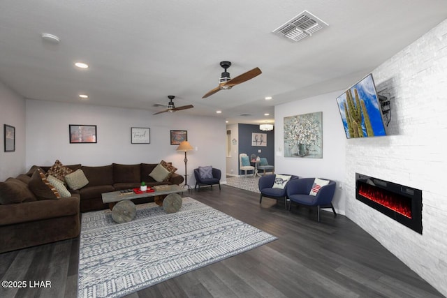 living area with ceiling fan, recessed lighting, dark wood-style flooring, a fireplace, and visible vents