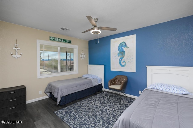 bedroom with visible vents, dark wood finished floors, baseboards, and ceiling fan