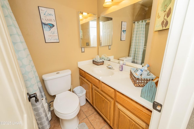 bathroom with tile patterned floors, vanity, and toilet