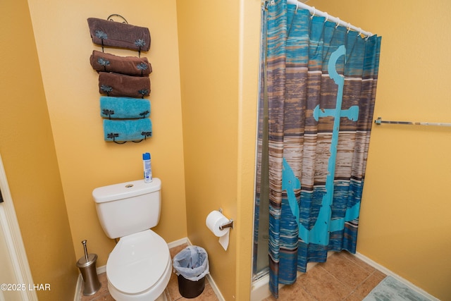 bathroom featuring a shower with curtain, tile patterned floors, and toilet