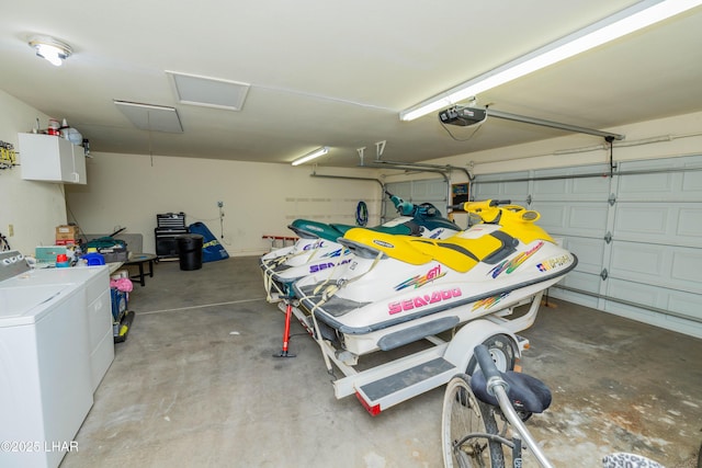 garage with a garage door opener and separate washer and dryer