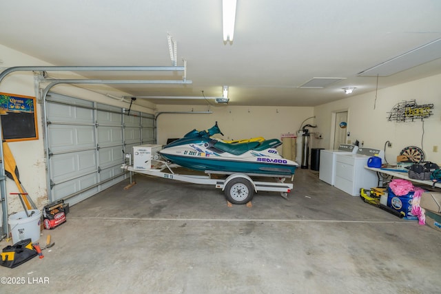 garage with a garage door opener and separate washer and dryer