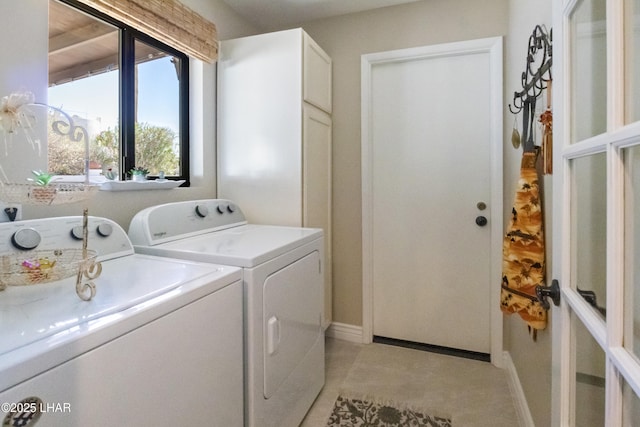 laundry area with cabinets and washer and clothes dryer