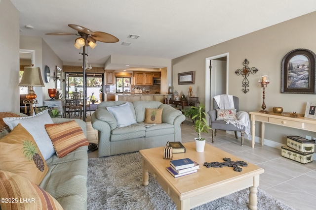 living room featuring ceiling fan and light tile patterned floors