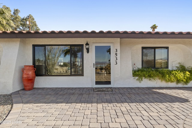 doorway to property with a patio area