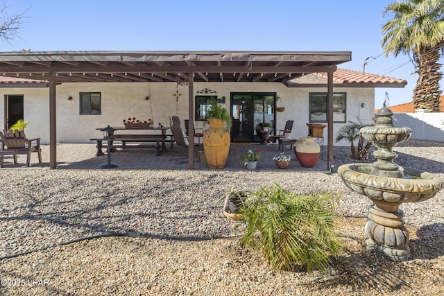 rear view of property featuring a patio area