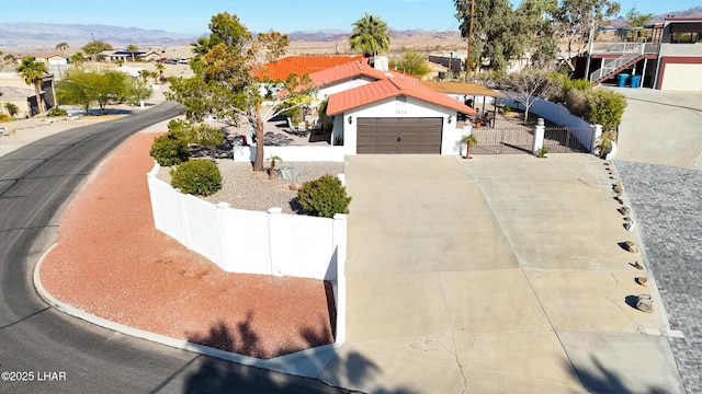 view of front facade featuring a mountain view and a garage