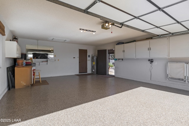 garage with a garage door opener and electric water heater