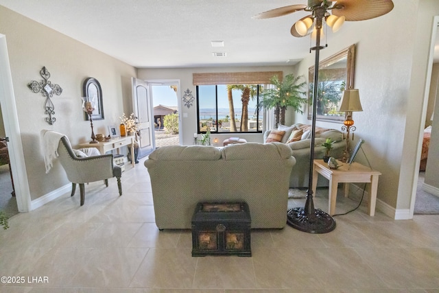 living room featuring light tile patterned flooring and ceiling fan