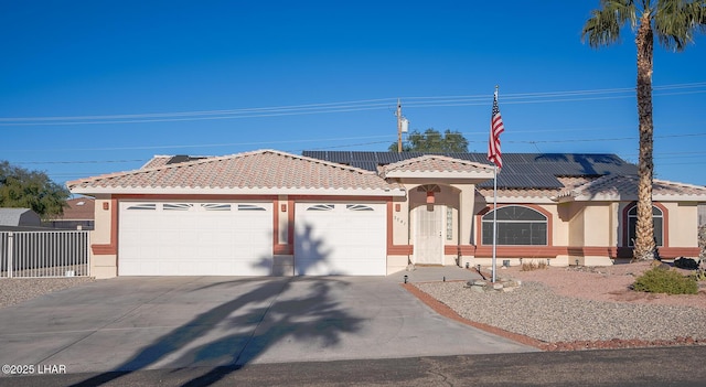 view of front of house featuring a garage and solar panels