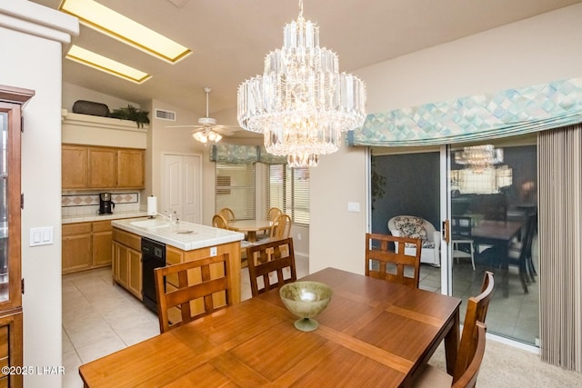 tiled dining room with ceiling fan with notable chandelier, lofted ceiling, and sink