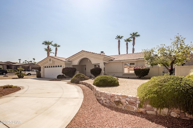 mediterranean / spanish-style home featuring a garage