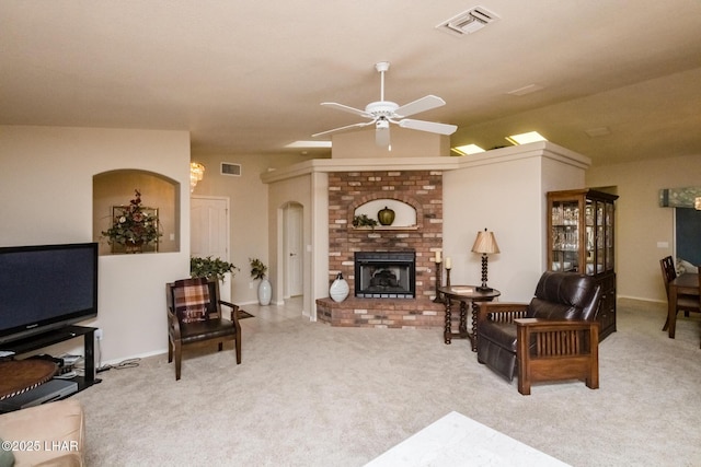 living room with a fireplace, light colored carpet, ceiling fan, and vaulted ceiling