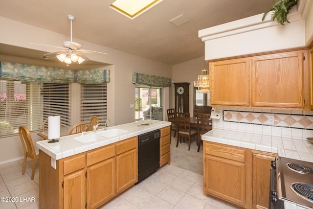 kitchen featuring sink, tile countertops, vaulted ceiling, dishwasher, and range with electric cooktop