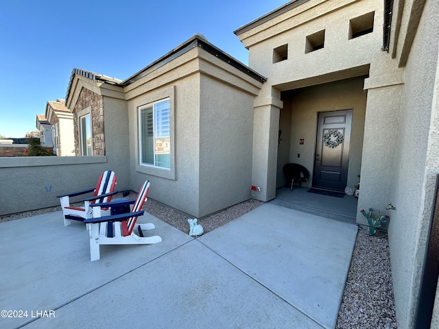 doorway to property with a patio area