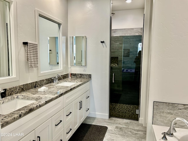 bathroom with vanity and independent shower and bath