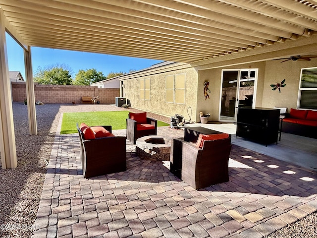 view of patio featuring an outdoor living space with a fire pit and ceiling fan