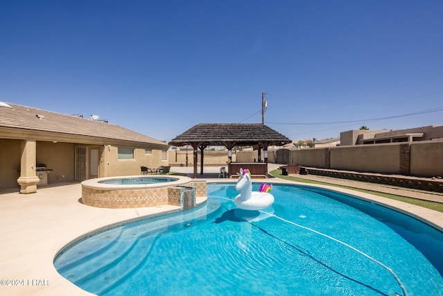 view of swimming pool with an in ground hot tub, area for grilling, a patio area, and a gazebo