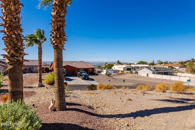 672 Wayside Dr, Lake Havasu City, AZ 86403 - view of yard featuring a residential view, a garage, driveway, and fence