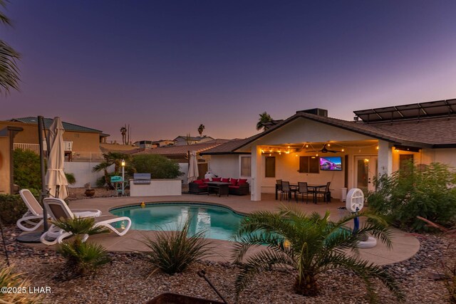 672 Wayside Dr, Lake Havasu City, AZ 86403 - pool at dusk with an outdoor hangout area, a patio area, fence, and outdoor dining area