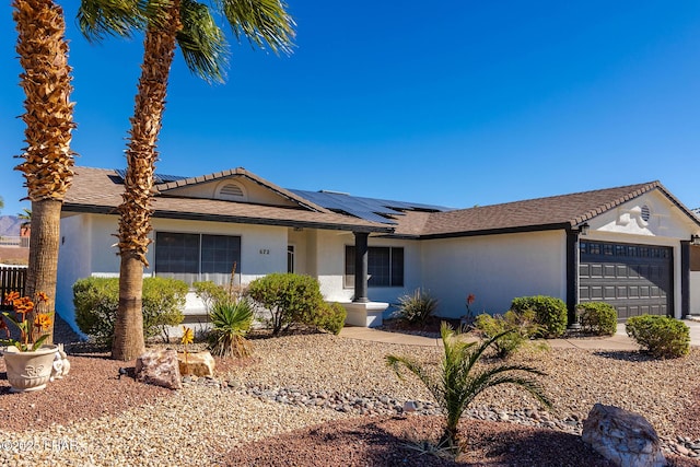 672 Wayside Dr, Lake Havasu City, AZ 86403 - ranch-style home featuring a garage, stucco siding, and solar panels