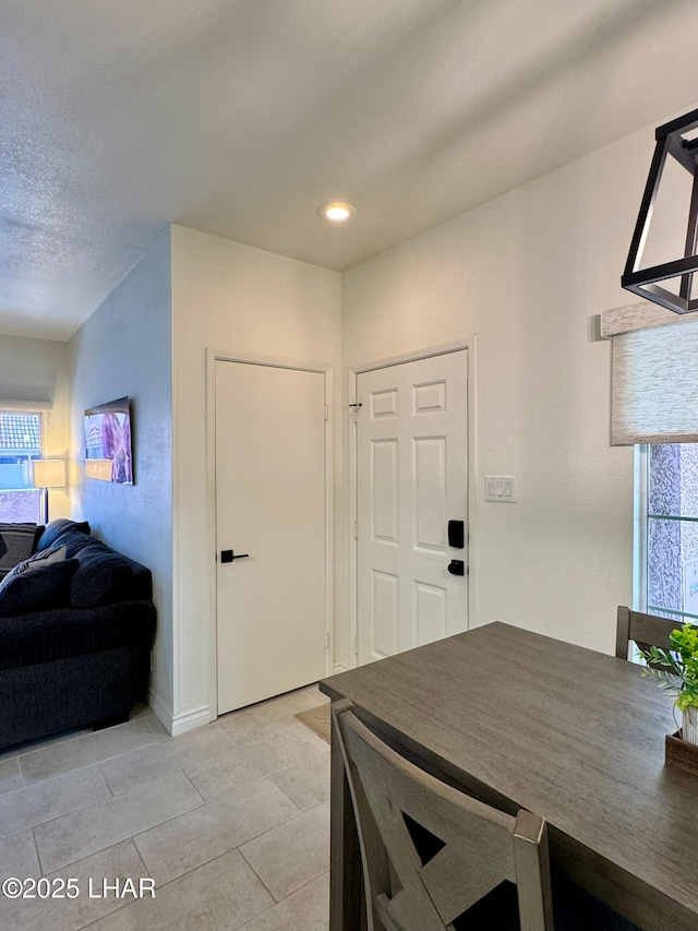 1650 S Smoketree Ave Unit 116, Lake Havasu City, AZ 86403 - dining room with healthy amount of natural light, baseboards, and light tile patterned floors