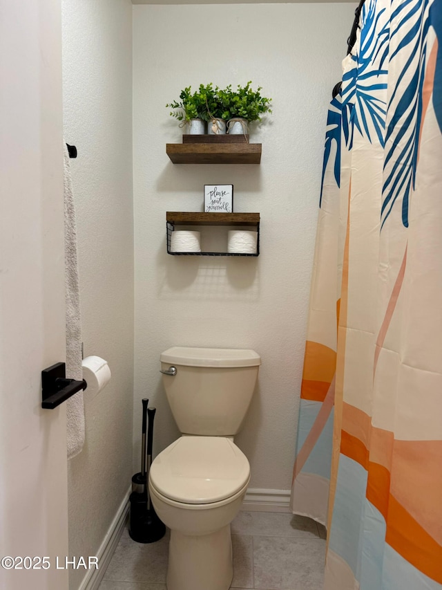 1650 S Smoketree Ave Unit 116, Lake Havasu City, AZ 86403 - bathroom with baseboards, toilet, tile patterned flooring, and curtained shower