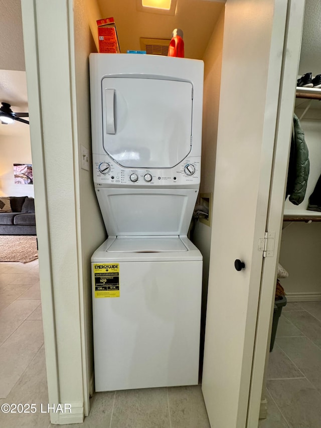 1650 S Smoketree Ave Unit 116, Lake Havasu City, AZ 86403 - laundry room featuring stacked washing machine and dryer and light tile patterned flooring