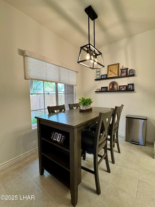 1650 S Smoketree Ave Unit 116, Lake Havasu City, AZ 86403 - dining area featuring a chandelier, baseboards, and light tile patterned flooring
