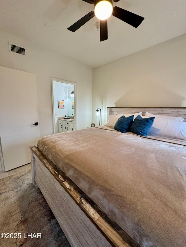 1650 S Smoketree Ave Unit 116, Lake Havasu City, AZ 86403 - bedroom with a ceiling fan, ensuite bath, and wood finished floors