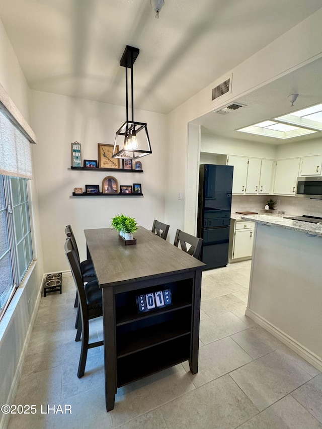 1650 S Smoketree Ave Unit 116, Lake Havasu City, AZ 86403 - dining room featuring light tile patterned flooring and baseboards