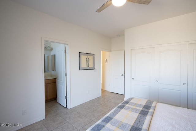 unfurnished bedroom featuring ceiling fan, ensuite bath, a closet, and light tile patterned floors