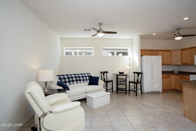 tiled living room with ceiling fan