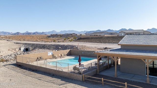 view of swimming pool featuring a mountain view and a patio