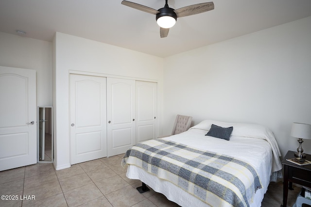 tiled bedroom featuring a closet and ceiling fan