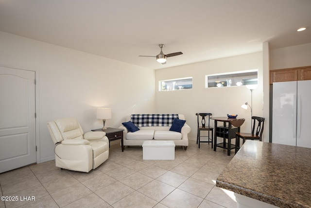 living room featuring light tile patterned floors and ceiling fan